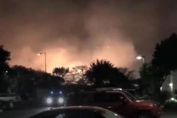 Brush fire that forced evacuation of luxury Maui resort is seen in background on January 6, 2019