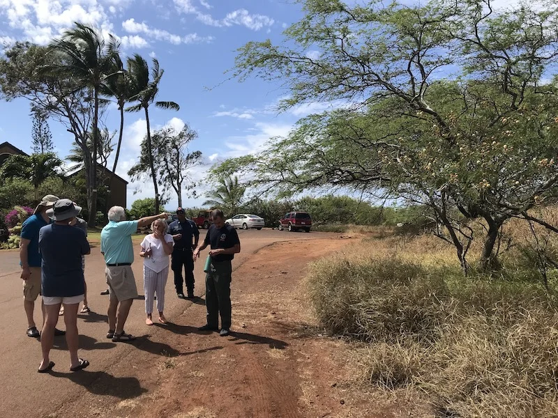The assessment crew pointing out vegetative hazards on the wildland-urban interface of Paniolo Hale.