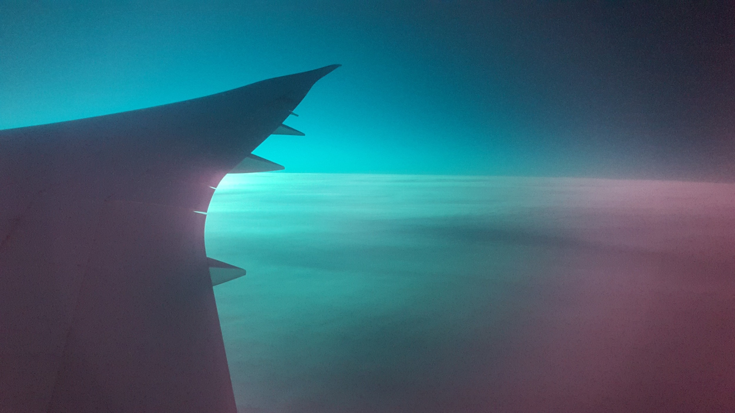 Crazy early morning light off the wing of our Boeing Dreamliner, somewhere over the Atlantic. 