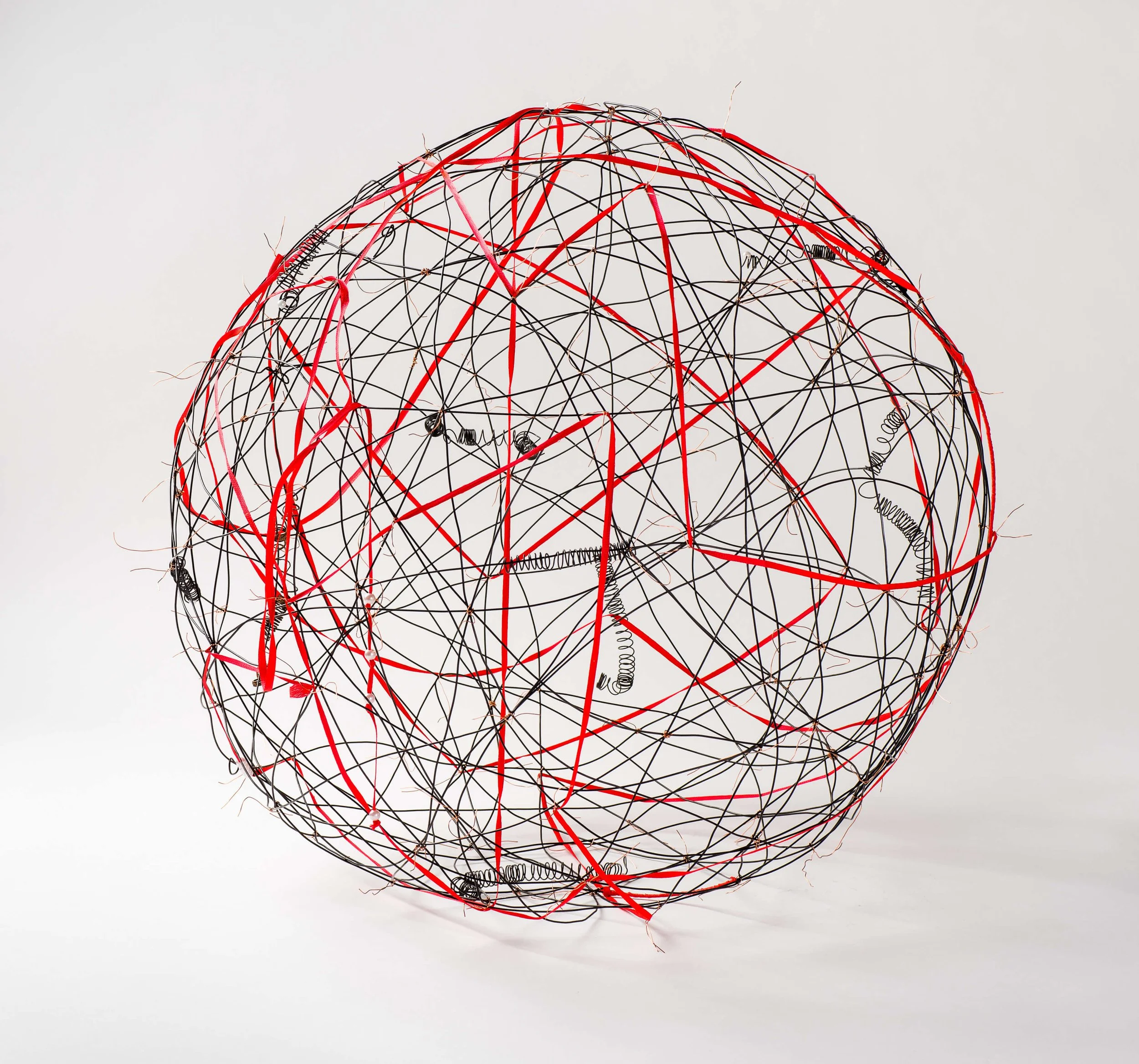 SHARED RED THREAD GALAXY: Rebar tie wire, red knit narrow good, handmade and found springs, fake pearls, 22 ½” (57cm) dia., 2015