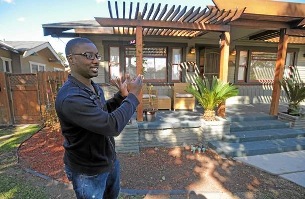 With four children now, Chad Clark is looking to sell his house in the Craftsman Village area of Long Beach and relocate nearby into a larger home. His house on 8th Street near Orange Ave. is on the market for $489,000. (Scott Varley / Staff Photographer)