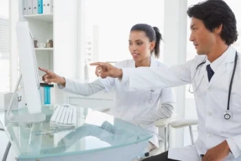 cutcaster-903673022-Two-doctors-pointing-to-computer-screen-small.jpg