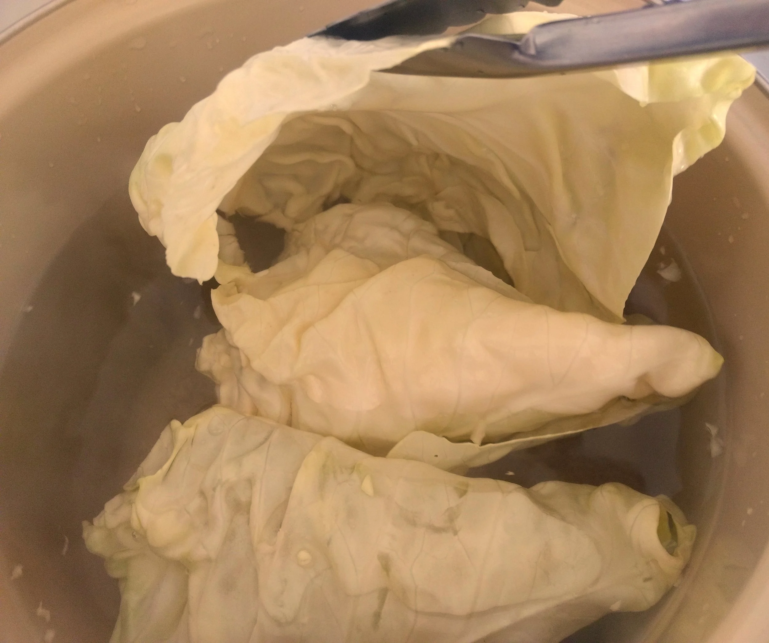 3-Add the cabbage to the boiling water, core side down. Let it cook until the top leaves start to separate from the head, 1–2 minutes.