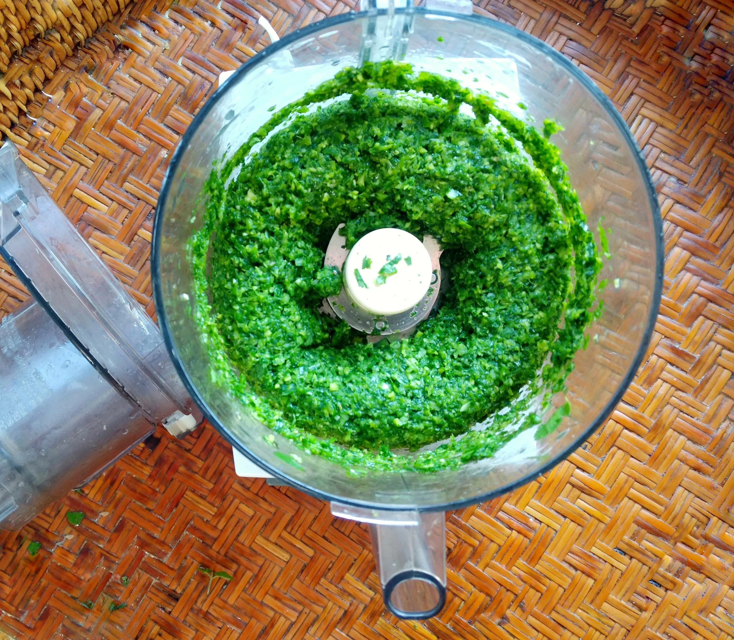 2 -Place the garlic and ginger in the processor and pulse to finely chop, then add the scallions, coriander, and to mince.