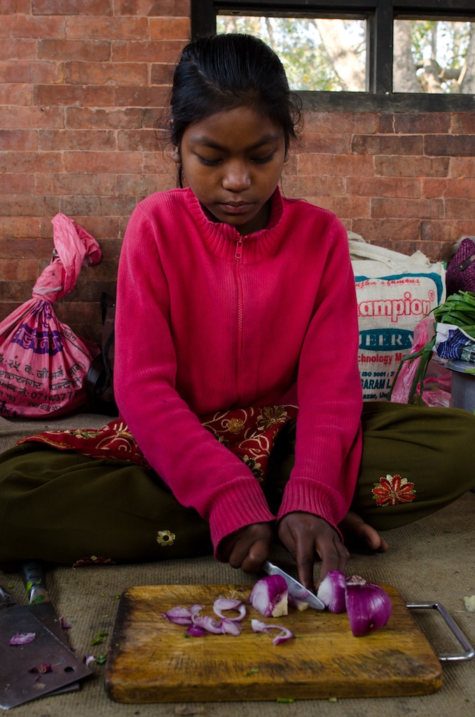 The children learn to cook, clean and look after themselves. Sunita is preparing vegetables for tasty dal bhat!