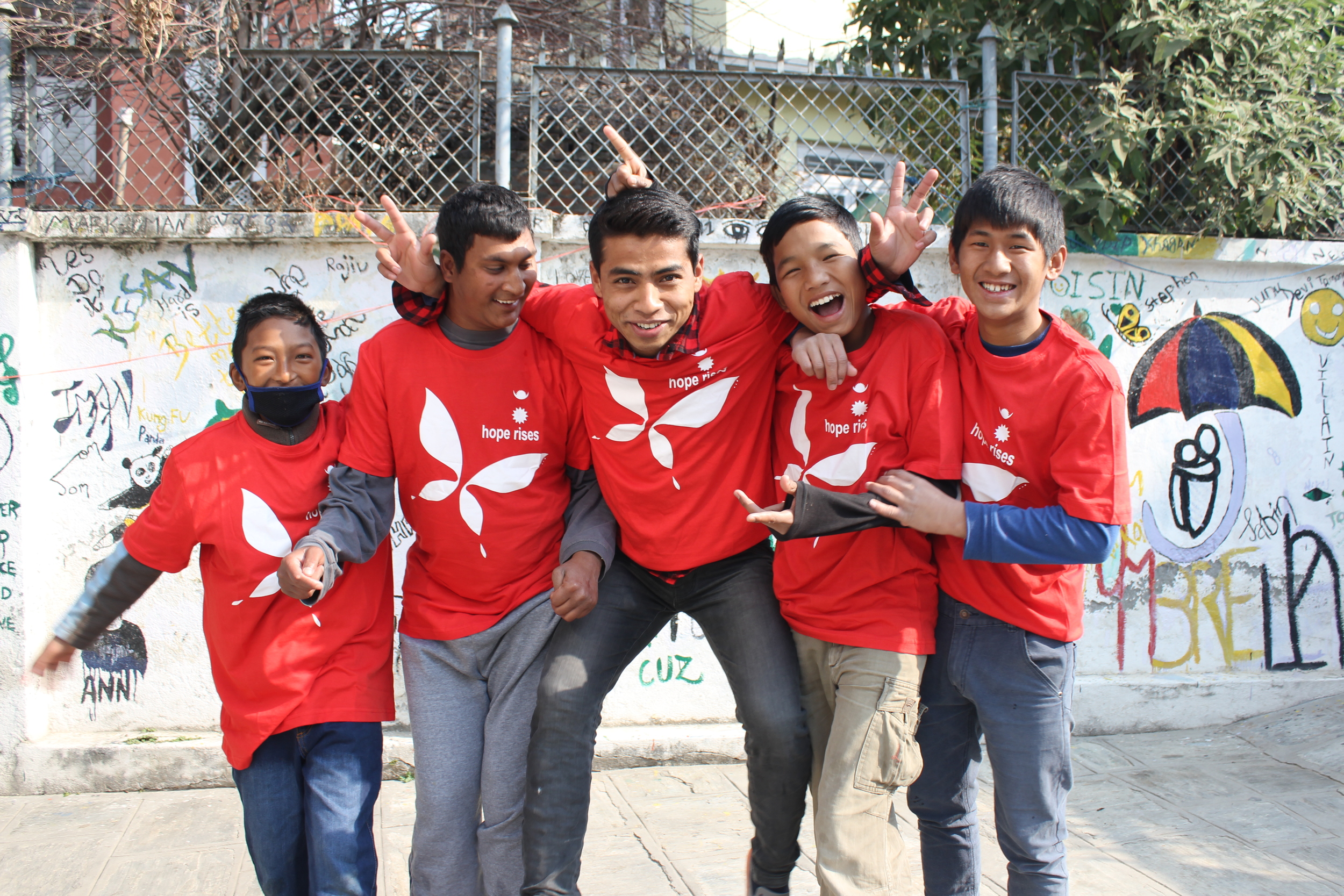 Umbrella boys modelling their Hope Rises Nepal shirts