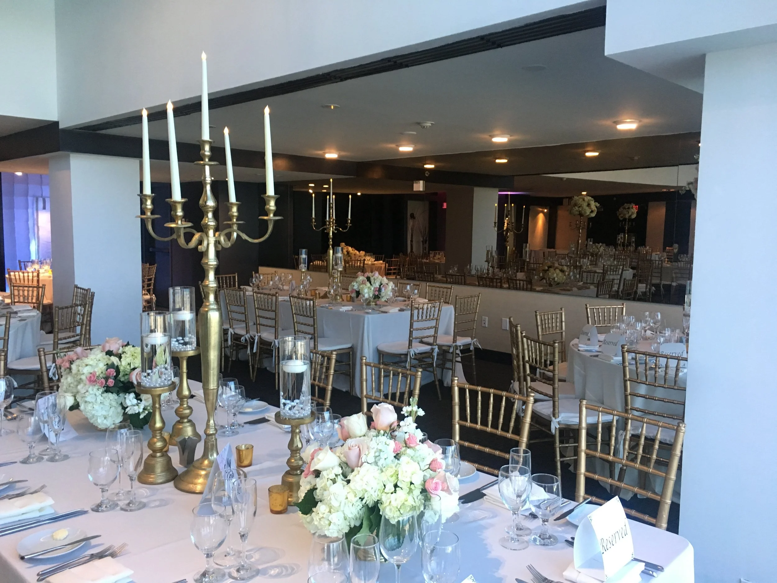 Wedding Reception Gold Chiavari Chairs white linen candles