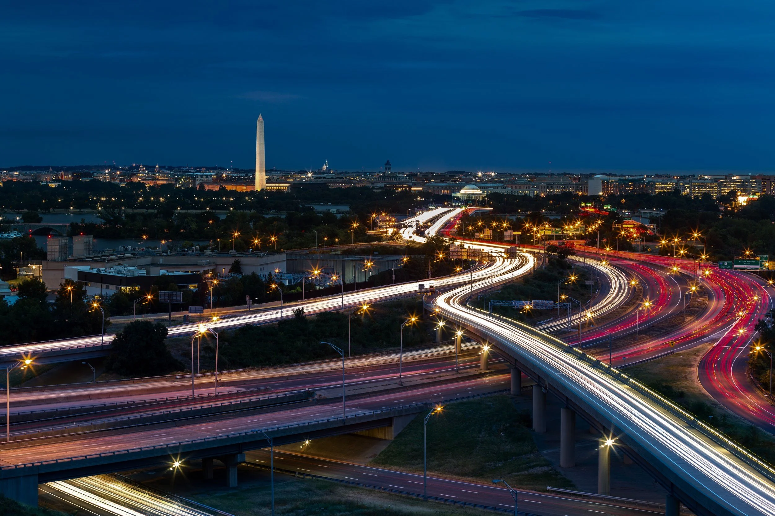 Washington+D.C.+cityscape+at+dusk+with+rush+hour+traffic+trails+on+I-395+highway.+Washington+Monument%2C+illuminated%2C+dominates+the+skyline.jpg