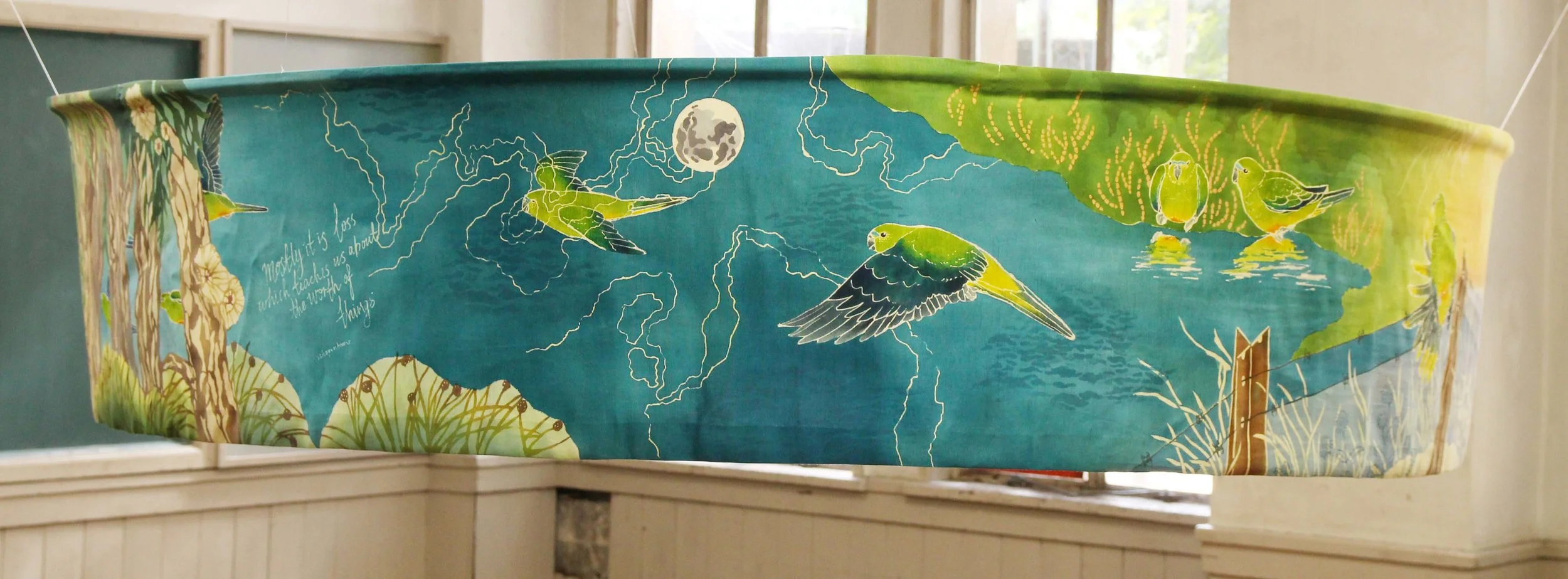 Loss & Worth, 2013. Katazome and Yuzen on silk. 4.5 metres long x 33cm high. A scroll scene depicting the migration of Critically Endangered Orange-bellied Parrots.Image forms a loop so the migration cycle continues.