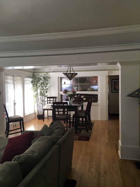 Large crown molding and plate rails surround the dining room.