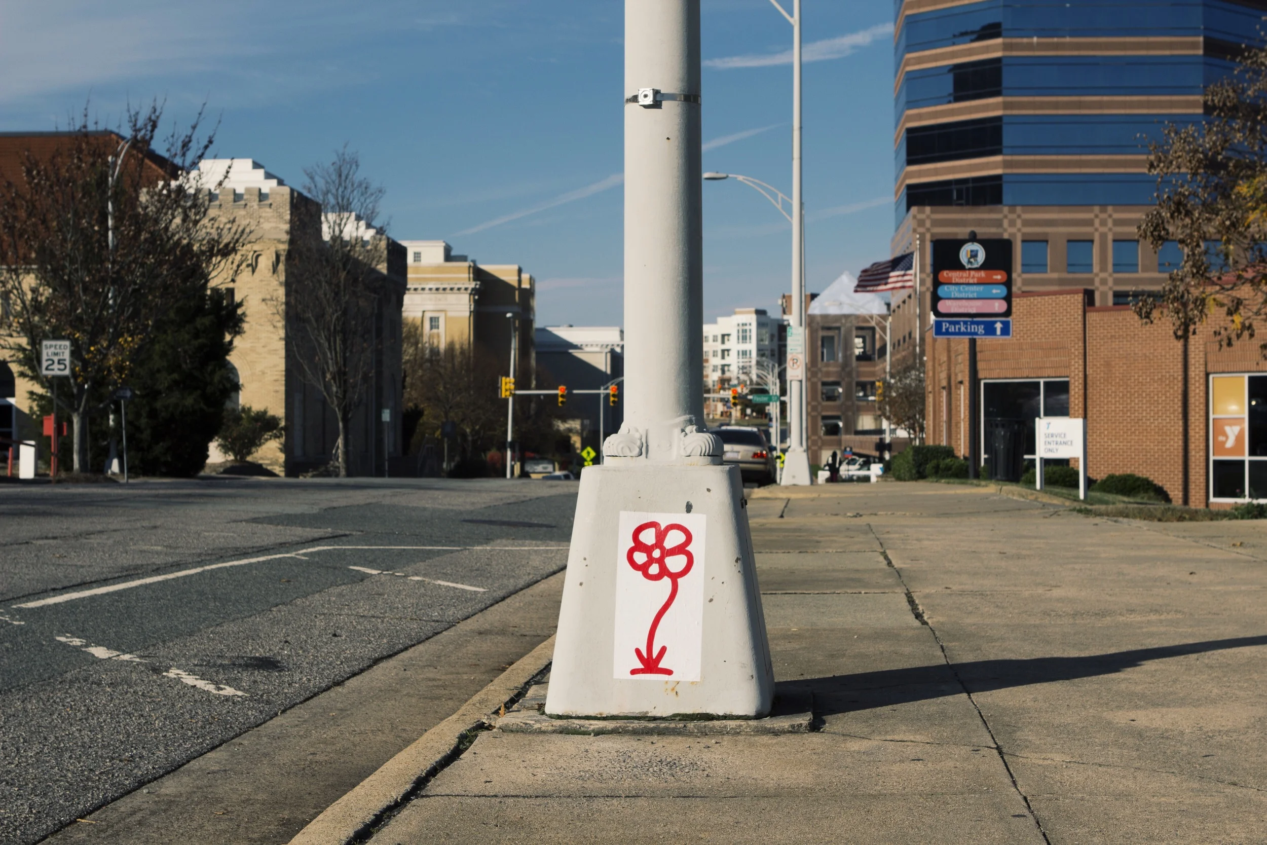 Red bloom greeting drivers entering the downtown Loop near the Carolina Theater