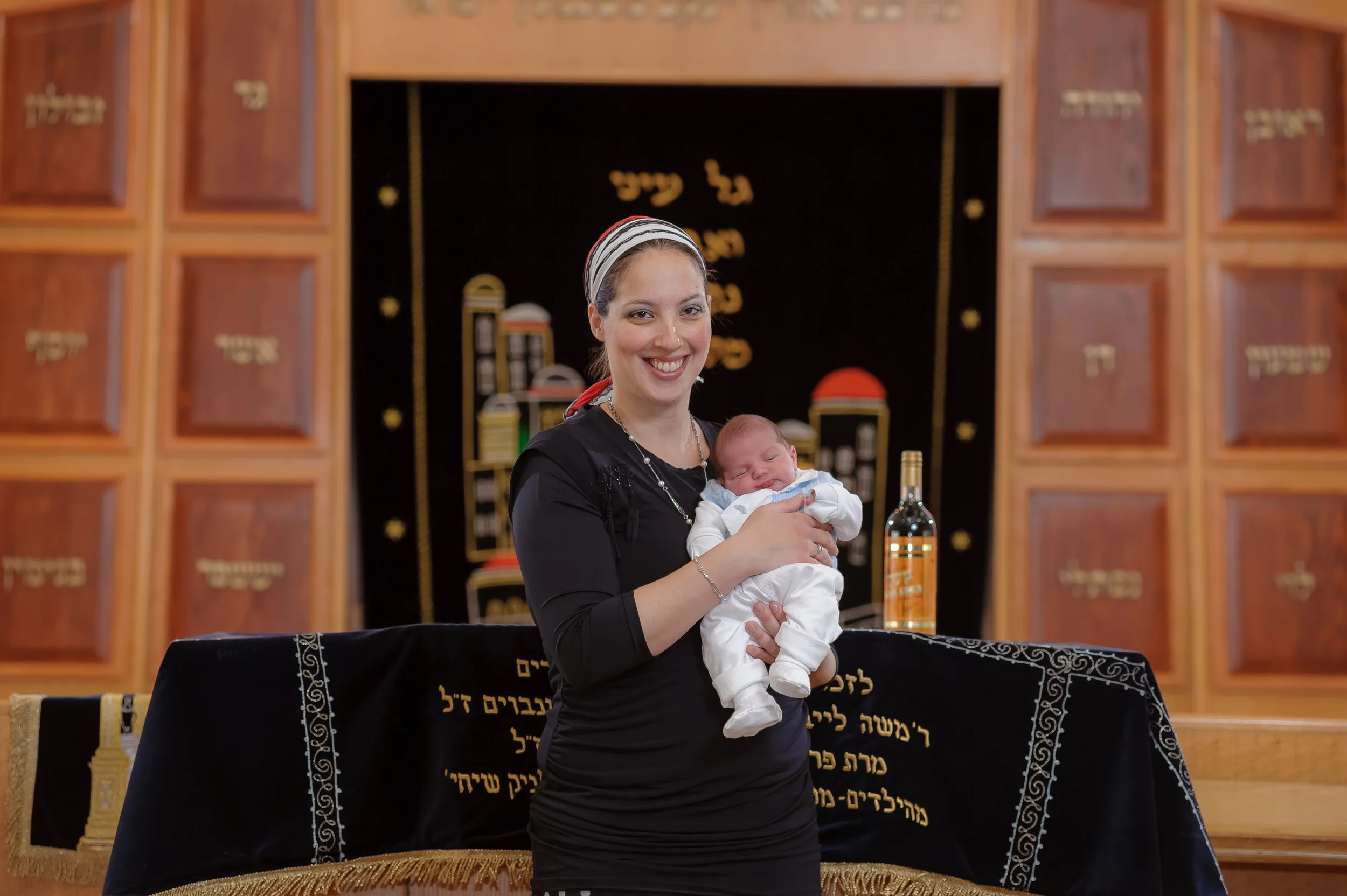 צלם לברית - צילום משפחה על רקע ההיכל בבית הכנסת.&nbsp;