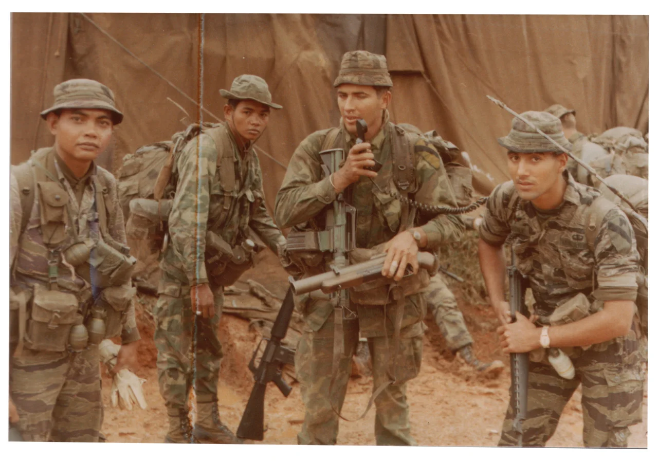 Commo check LZ Betty. Montagnard scouts, Cpls. Pong and Puk, Sgt. Parkinson, and me