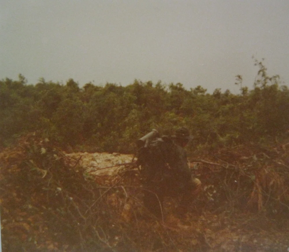 My front scout, Tony Griffith (KIA 2/5/69), keeping watch by a shell crater