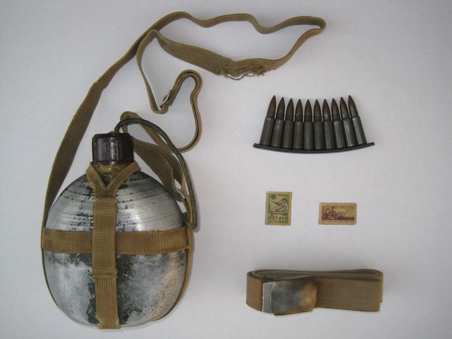 The sniper's canteen, stripper clip, postage stamps, and belt