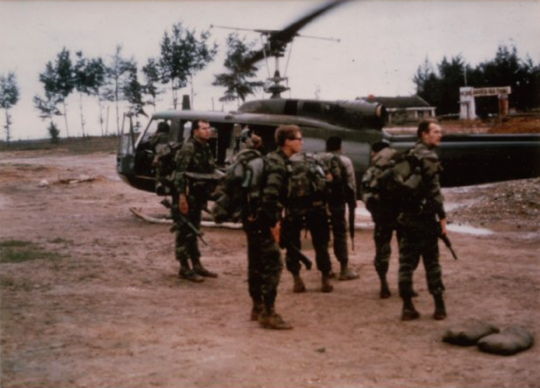 February 12, 1968. Forrest Decker, center. I'm behind him checking another man's gear. We're en route to a patrol just days after the Tet Offensive--the biggest battle of the Vietnam War