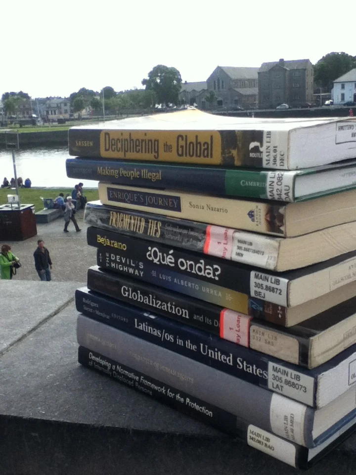 My stack of library resources for my thesis. Plus two books that I own and carried with me all the way from Oregon to Ireland. Pictured here on the balcony of my apartment in Galway, overlooking the Corrib river.