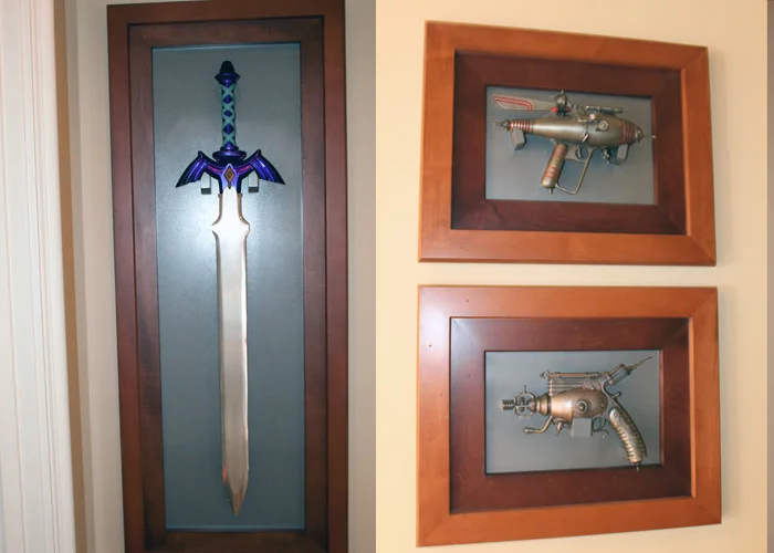 LEFT: We won a 2 of a kind Master Sword (made by Nintendo and used in a Zelda commercial) at a child charity event auction Nite2Unite. RIGHT: Clifford's Dr. Grordbort 's weapons he acquired at various Comic Cons. (These are right outside the game room, in the hallway.)