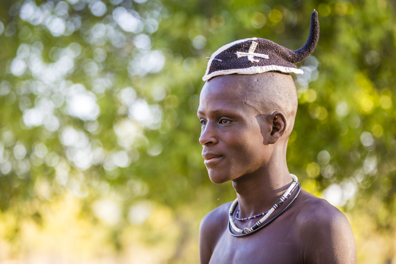 The prime of his life... Himba boy entering adulthood wears his hair in a simple braid to the back of his head. This will be covered by a turban once he is married. Soba, Cunene Provence ©24Atlantic