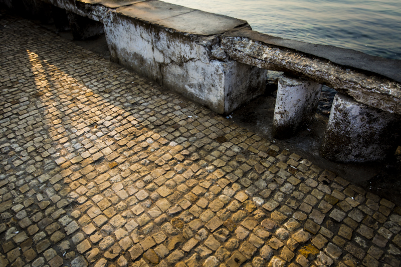 Cobblestone sidewalks, crumbling walls... remnants of Portugese Colonialism. Lobito, Benguela Provence ©24Atlantic