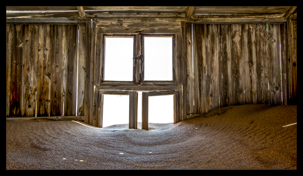 Filling up like a sinking ship...structures are continually being covered up with sand only to be exposed again years later.