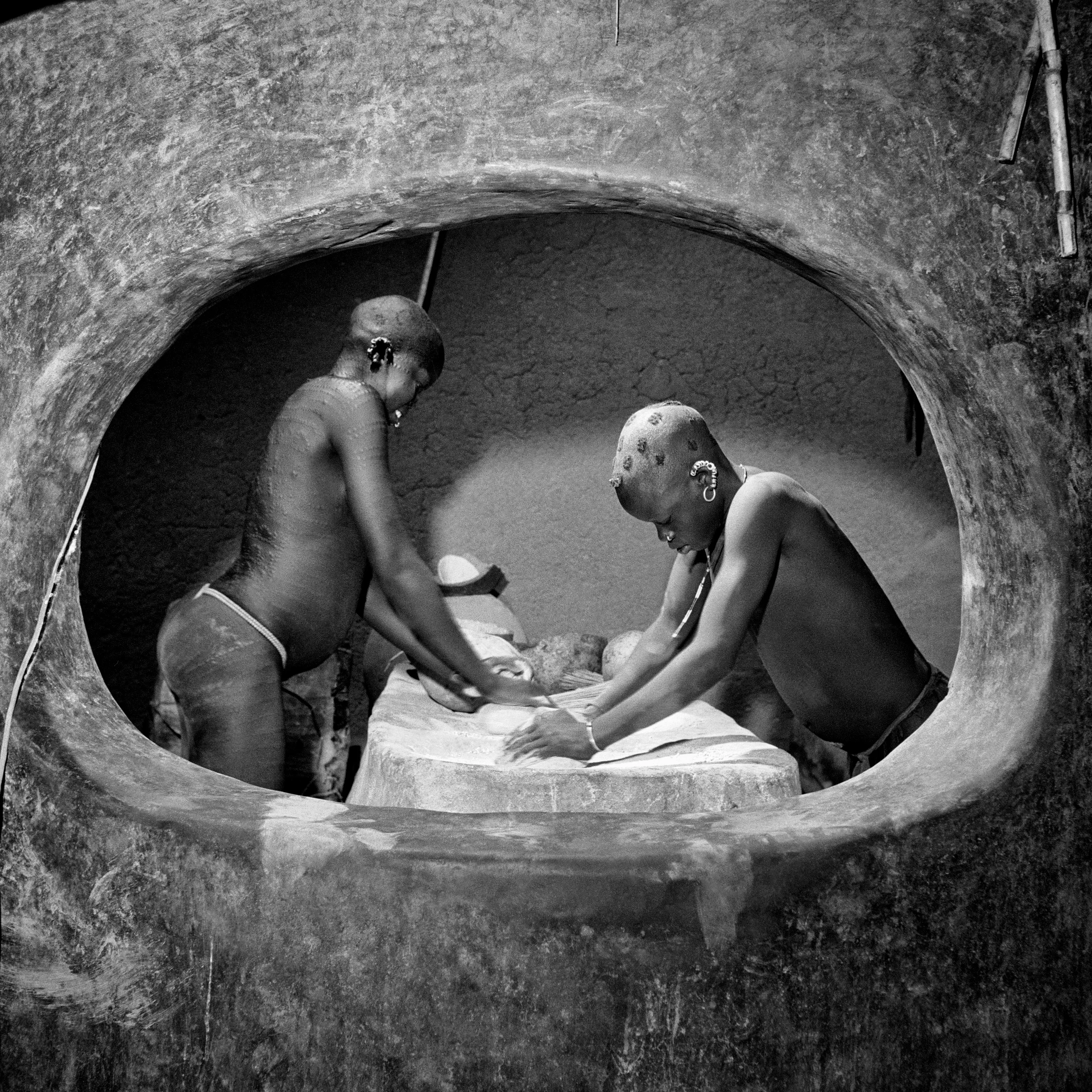 Korongo Nuba women in the granary room of their house, Kordofan, Southern Sudan
