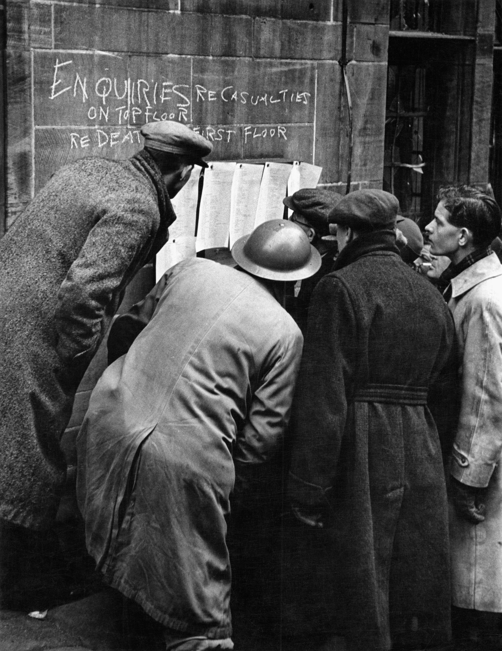 Lists of the dead and wounded are posted on the walls of City Hall, Coventry 1940