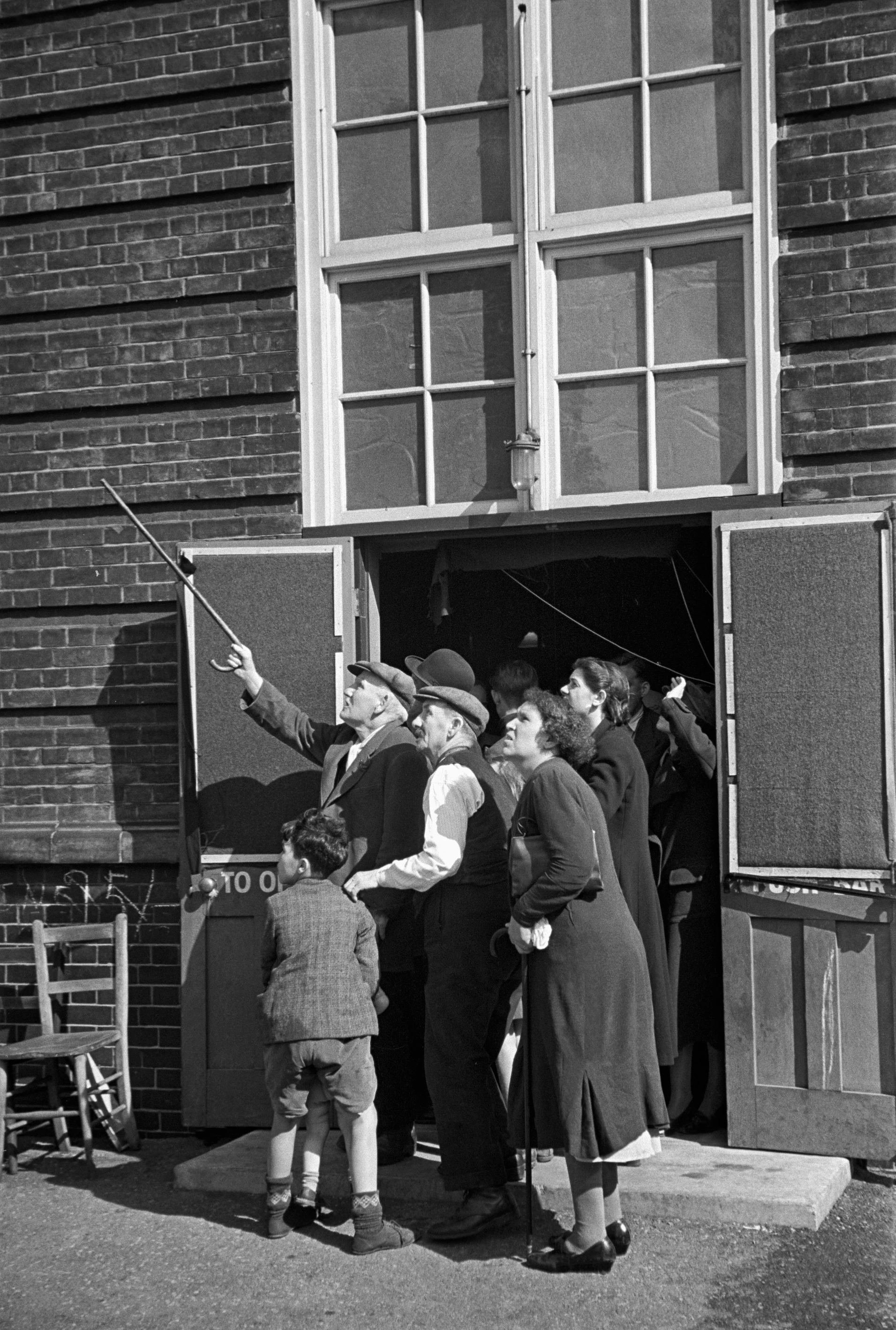 Watching a day-time from a shelter entrance, London 1940