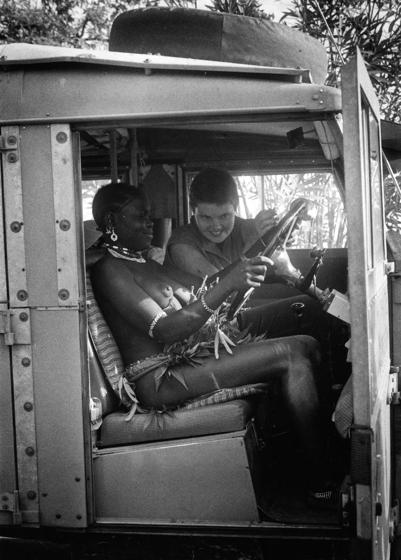 Jinx gives a driving lesson to her young Kikuyu friend, Kenya 1954