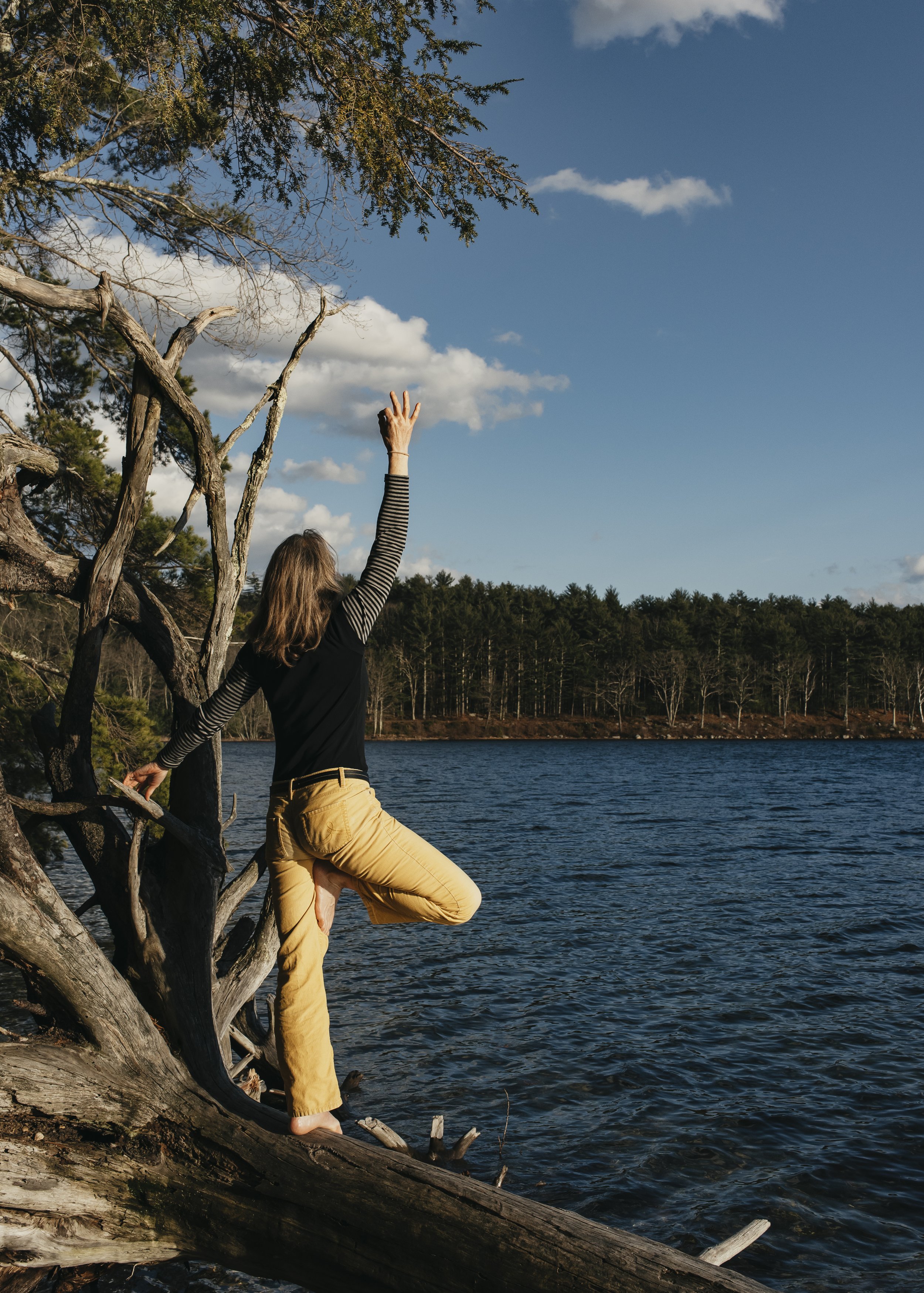 Katie doing yoga pose and looking at body of water