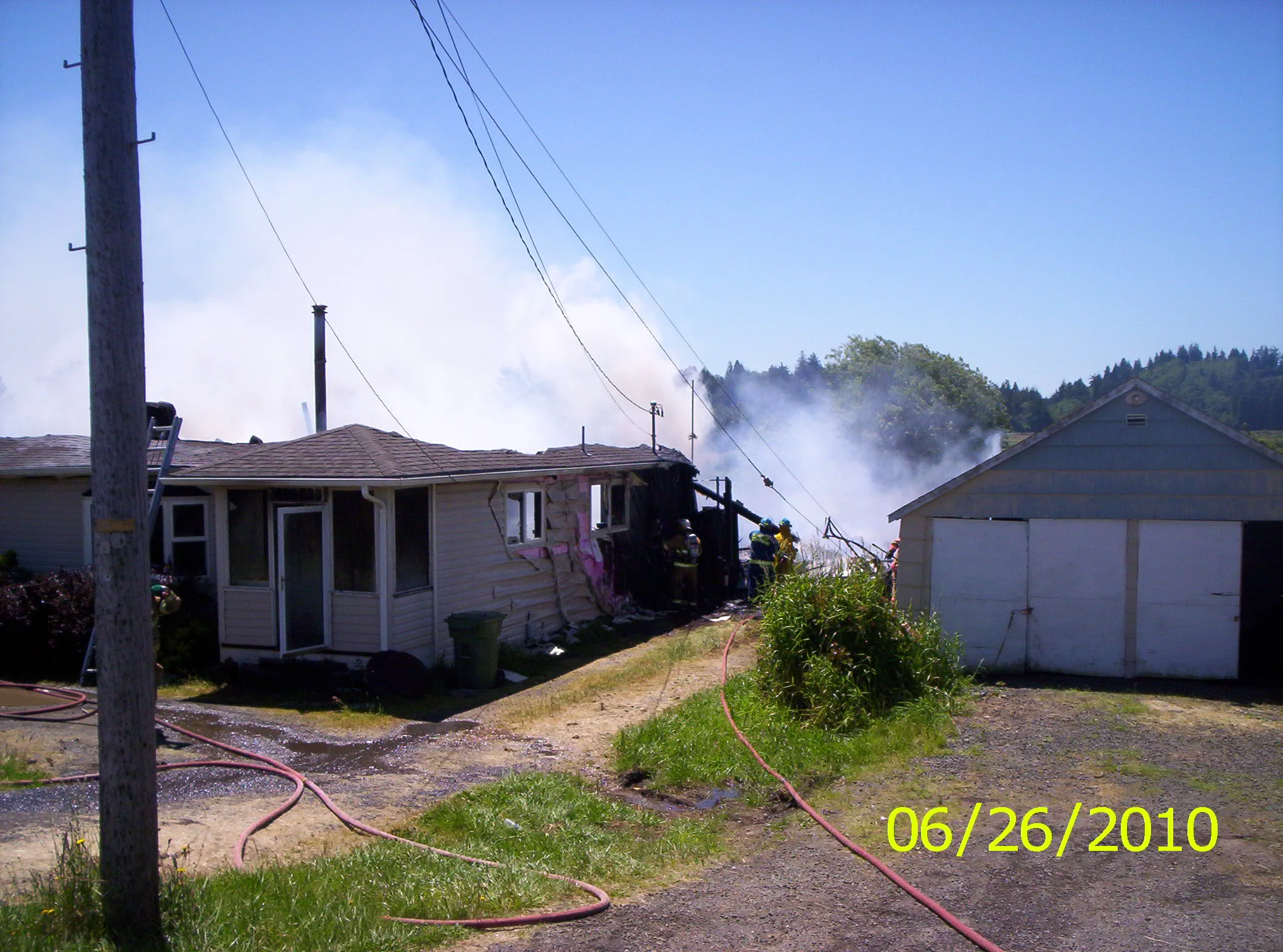 WORKING FIRE - BURNS SIDE OF NEXT DOOR GARAGE - HWY 241