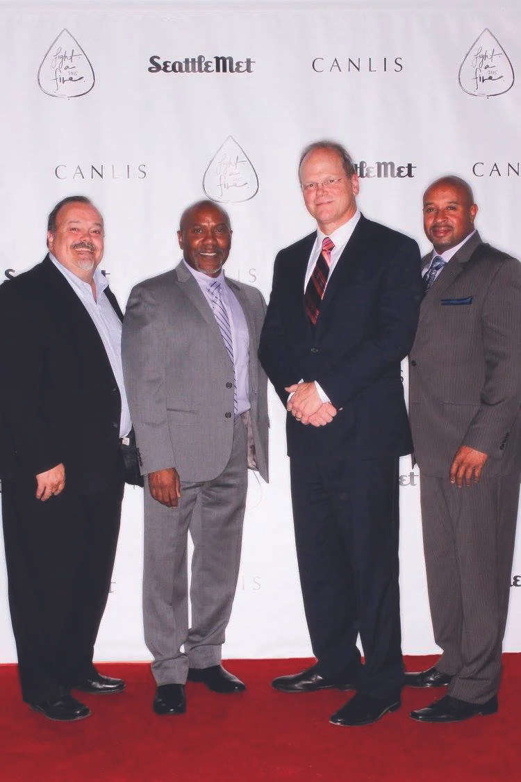 Co-Program Directors, Dominique Davis and Terrell Dorsey with Urban Impact’s Executive Director, Steve Bury, and King County Prosecuting Attorney Dan Satterberg. Image by Phototainment via The Seattle Met