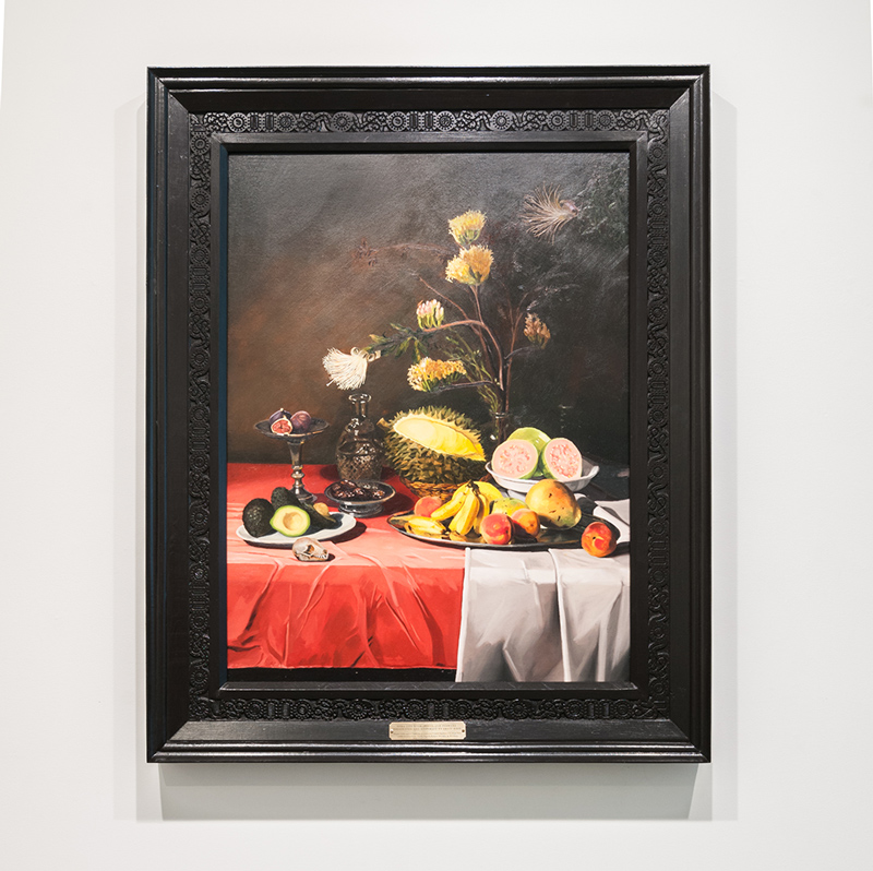 Still life with fruits and flowers pollinated and dispersed by fruit bats , 2016 Oil on canvas on panel, carved frame with representations of Zoonotic Viruses harbored by fruit bats: SARS-Corona Virus, Ebola, Nipah, Rabies, Hendra, & Marburg 40 x 50 x 3.5 inches
