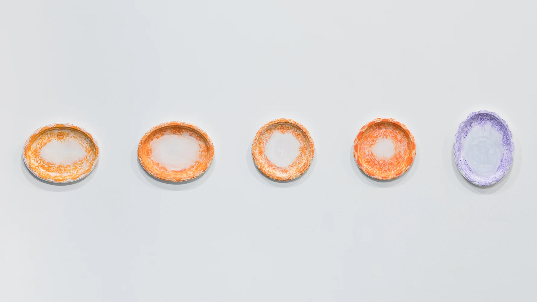 left to right: Not Blue , 2017; Waiting For the Other Shoe , 2017; Gossip Bridle , 2017; Gossip Bridles , 2017; Too Sad to Tell You , 2018 each: acrylic and day glow on gessoed Chinet plate or platter