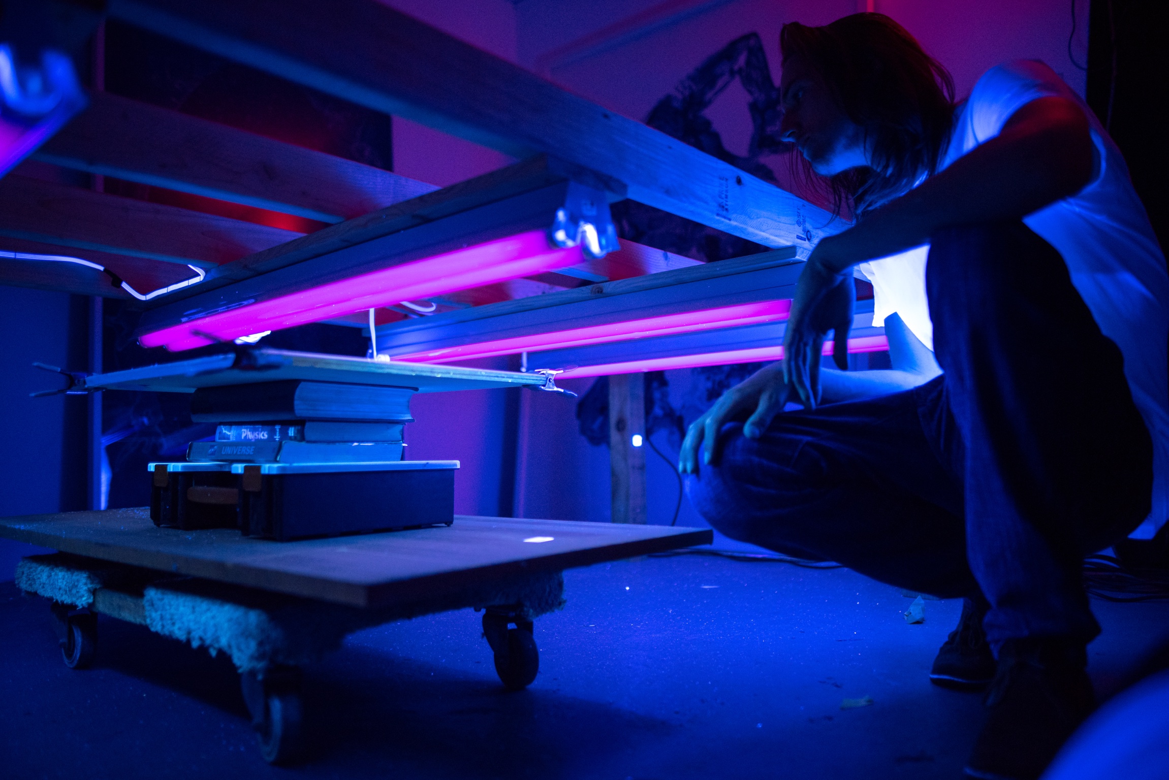 Garret kneels over Henrietta as we patiently wait over forty minutes for her to produce some tangible prints that prove her existence necessary. By this point, we had propped our test print up with books to decrease the distance from the lights, thereby increasing their intensity/effect. 