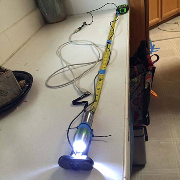 This $4 webcam got snagged in the vent. After managing to yank the tape measure out, I still wanted to retrieve this flashlight.