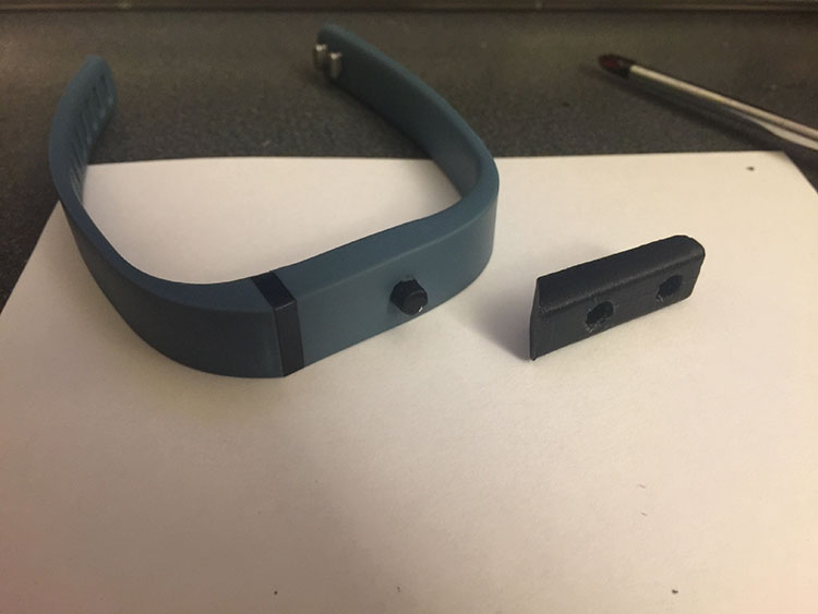  Fit-bit band used as a mounting point for Arduino. 3D printed a blank to replace the electronics and added a mountain peg. 