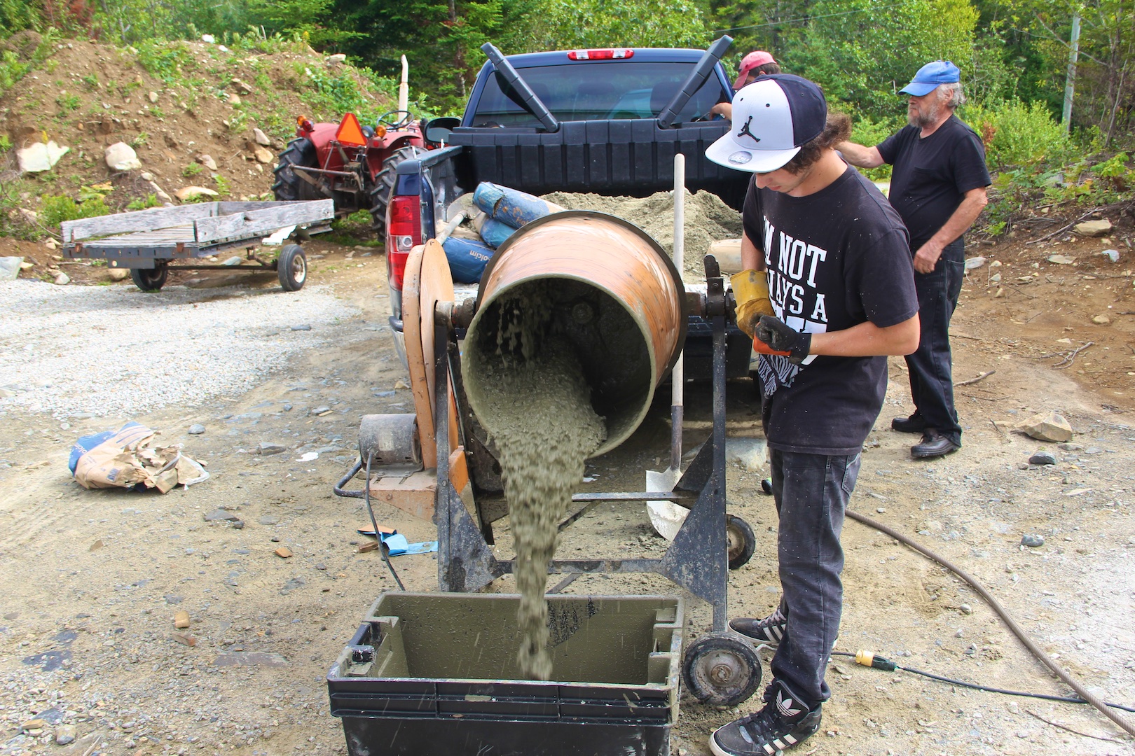 Alex handling the cement mixer like a pro