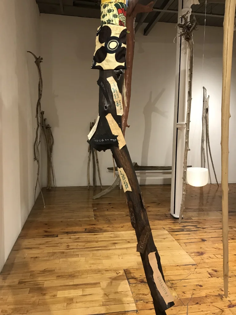 Around The World: Unity in Diversity (Detail) , 2017 - 2018 12 driftwood tree trunks, multi-cultural fabrics, paper ”barks"