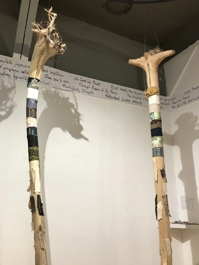 Around The World: Unity in Diversity, 2017 - 2018 12 driftwood tree trunks, multi-cultural fabrics, paper ”barks" Installation view at the Red Head Gallery Mottos of Many Countries , 2018 Paper, ink, mottos from Wikipedia Installation view at the Red Head Gallery