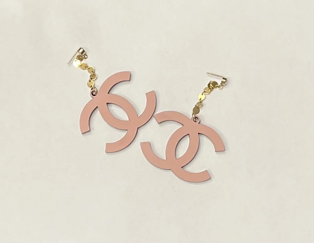 pink logo earrings on white.jpg