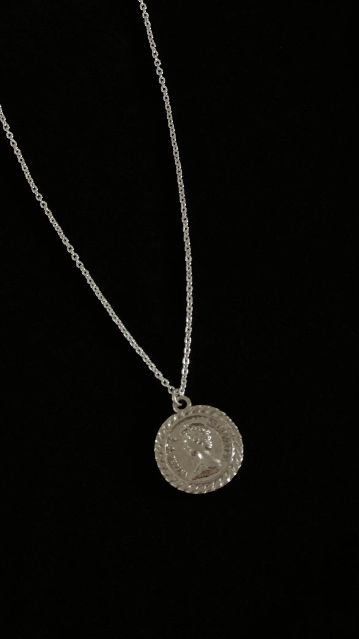 silver coin charm side view on blk.JPG