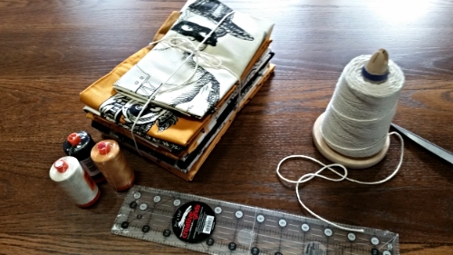 I found my store string and bundled up a tempting portion of prints and panels from Sew Scary, added a Creative Grids Ruler and then sprinkled generously with Aurifil threads! 