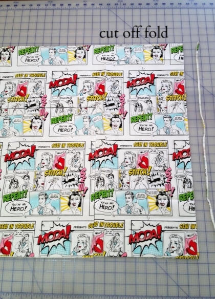 Start with 2/3 of a yard of Moda Super Heroes canvas fabric. Trim off the selvedge edges and the fold edge with a rotary cutter. Keep the edges square and straight.