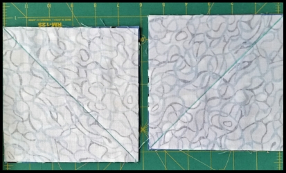 Draw a diagonal line on the back of the light squares. Please note that because my blue block fabric is directional , I need to draw one of my diagonal lines in the opposite direction of the other line, This will keep all my HST positioned correctly in the finished block.....or it is much easier to say it keeps all my sharks swimming in the right direction ☺