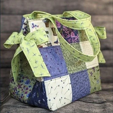 Back in stock by request: Box Bottom and Bows Tote Pattern! This darling tote showcases a collection of assorted five-inch squares. Stabilizing the bag with Soft and Stable maintains the shape of the bag. An added bonus? It also accentuates the quilt