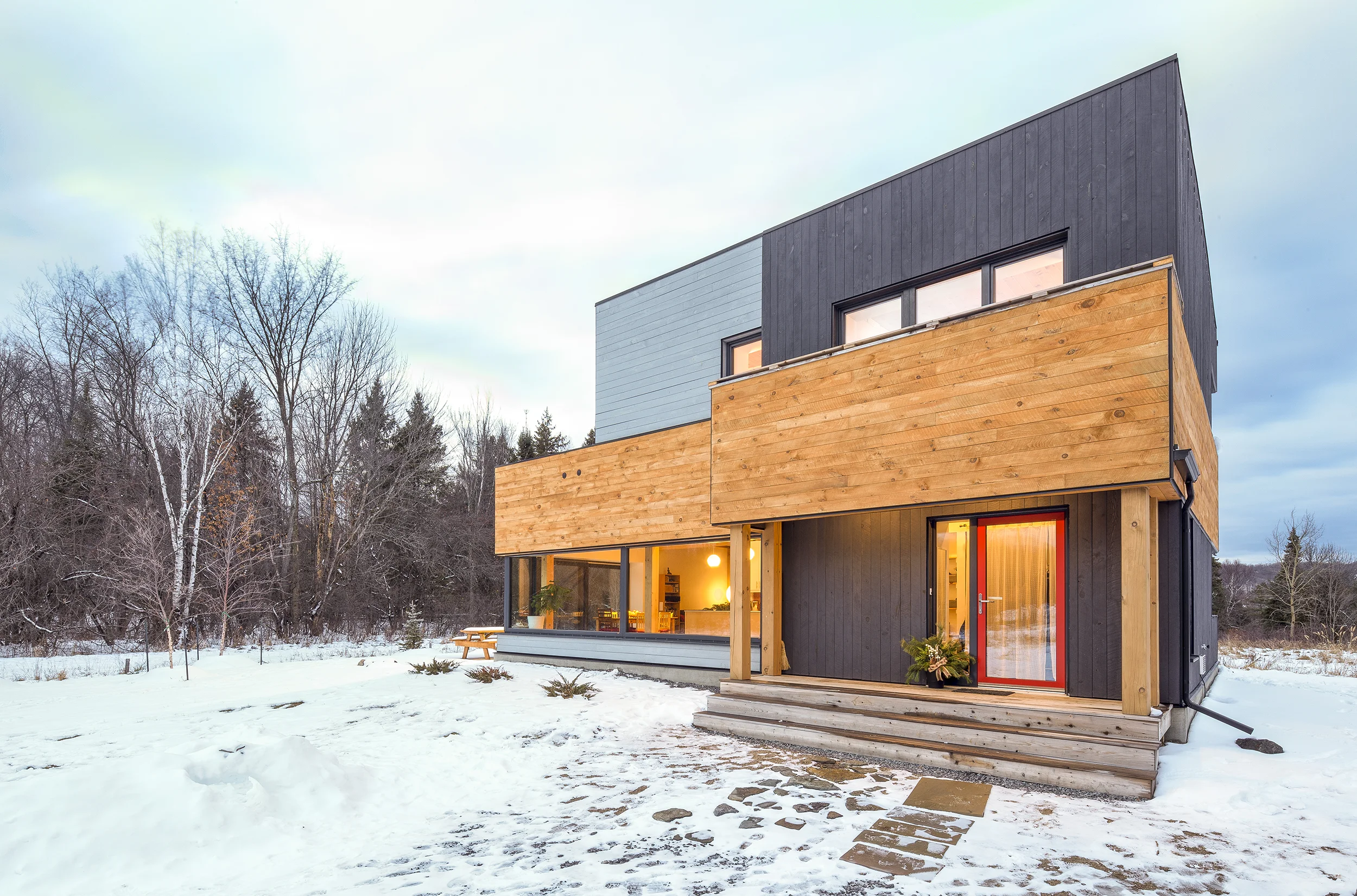 Exterior view of completed new design of Chelsea Passive House taken in winter