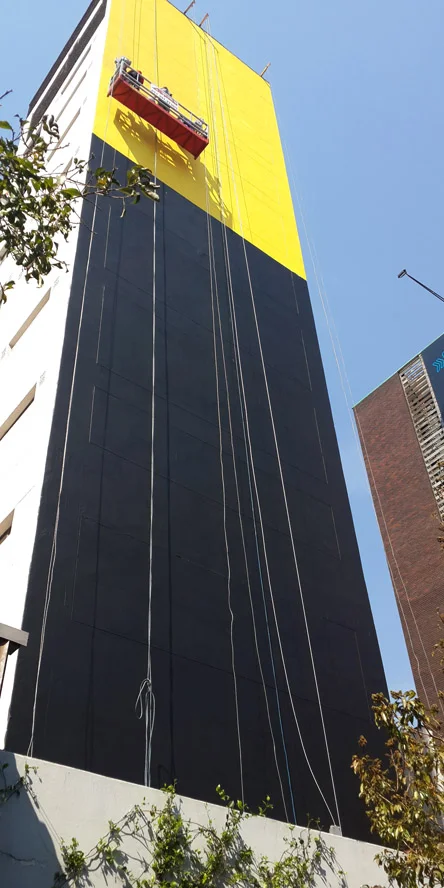 SHEPARD FAIREY beginning the large Nelson Mandela mural on that wall in that place (Braamfontein) for that brand (alcohol)