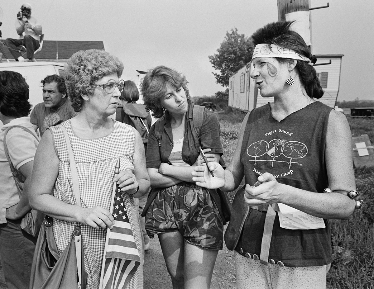 Neighbors and peace camp member try to understand one another.