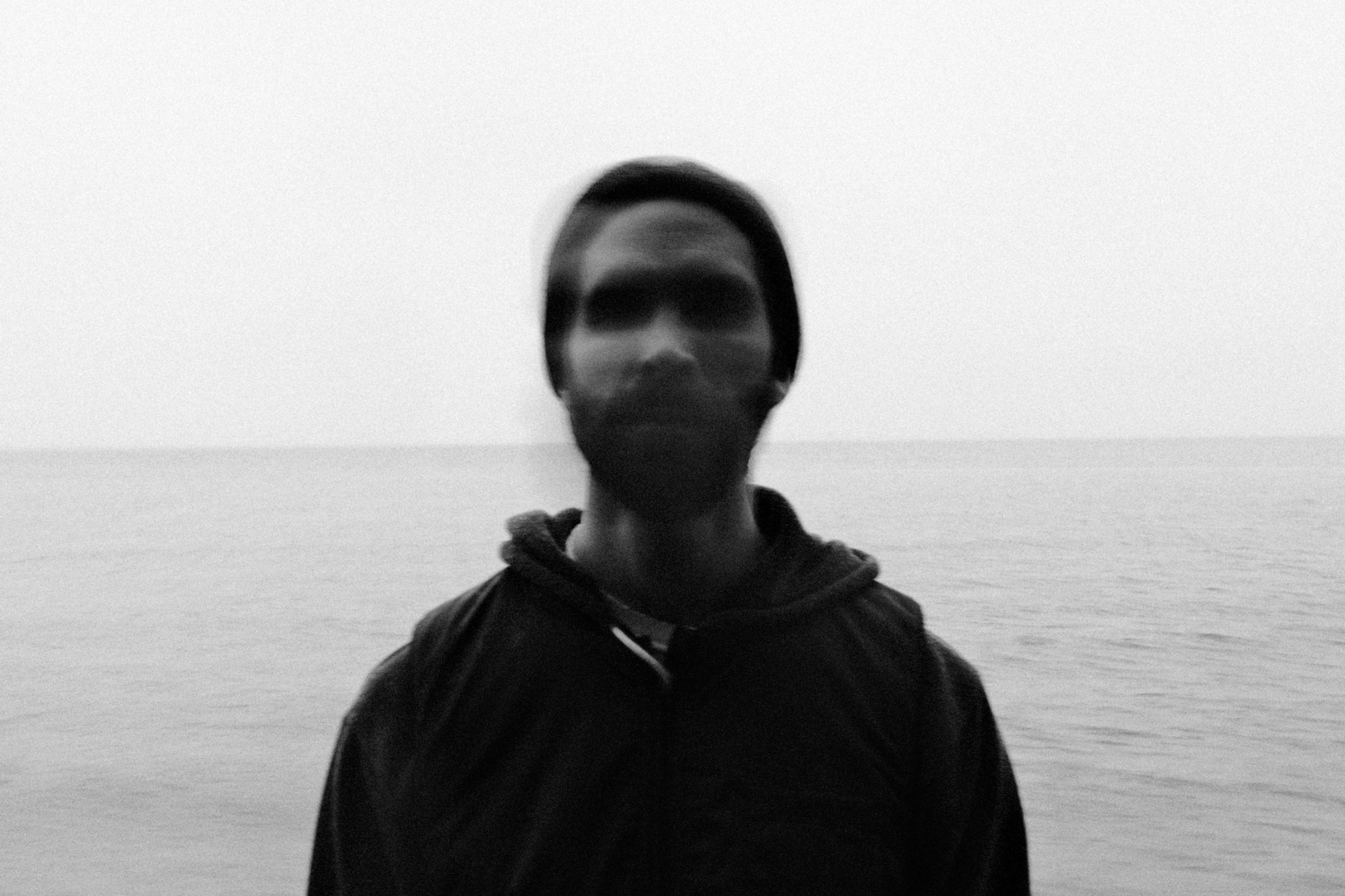 Moody B/W beach portrait with blurred face — fine-art style by Tom L A Jones